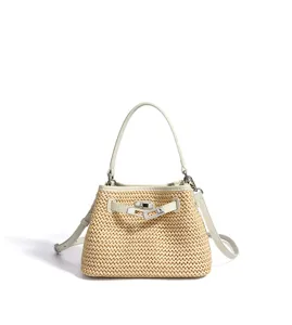 Detail view of the woven straw bucket handbag featuring leather trim and metal turn-lock clasp.