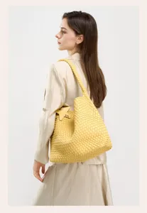 Yellow hand-woven leather hobo shoulder bag large capacity casual fashion tote bag.