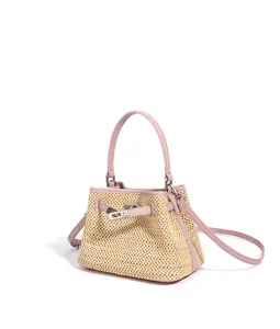 Straw shoulder handbag for women, pink leather trim, summer vacation style bucket bag.
