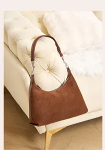 Detailed shot of the brown suede shoulder underarm bag showcasing exquisite leather texture.