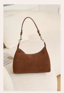 Brown suede hobo shoulder bag detail shot, showcasing soft texture and metal hardware.