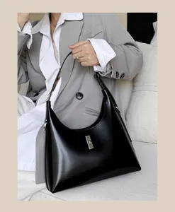 Black leather shoulder bag with metal lock detail, chic minimalist design for women daily wear