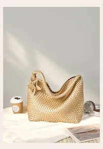 Gold woven shoulder bag, elegant braided tote bag with star pendant, chic daily handbag.