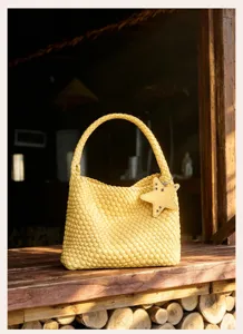 Yellow woven leather bucket bag with star charm detail for women beach holiday.