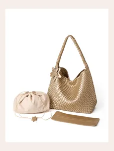 Golden woven hobo bag detail shot, featuring detailed leather texture and matching pouch.