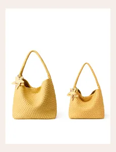 Detail view of two yellow woven leather hobo shoulder bags with chic star charms and straps.
