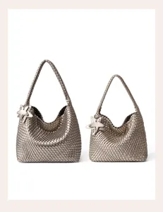 Detailed view of metallic silver woven hobo shoulder bags with cute star charm pendants.
