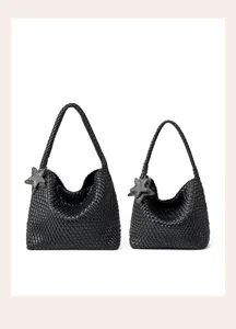 Black woven leather shoulder bag detail, showcasing intricate handcrafted texture and star charm.