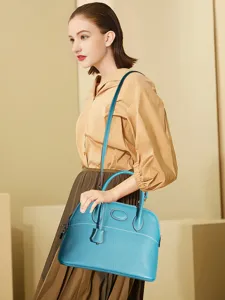 Blue leather dome handbag for women, classic top-handle shoulder bag with large capacity.