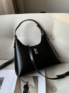 Classic black leather shoulder bag for women, chic hobo handbag with metal lock design.