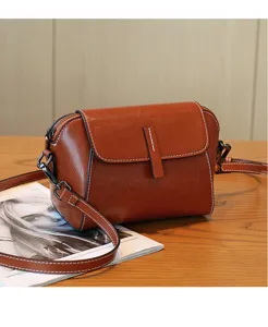 Vintage brown oil wax leather crossbody bag for women, stylish flap shoulder bag with strap.