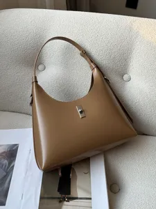 Chic brown leather shoulder bag for women, stylish minimalist hobo handbag with metal lock.