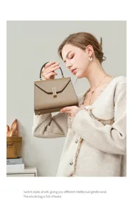 Elegant leather top-handle handbag for women, chic commuting shoulder bag with metal lock.