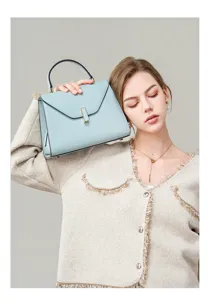 Light blue leather top handle shoulder bag for women, elegant commuting handbag with metal clasp.