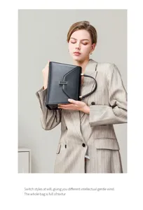 Elegant genuine leather black handbag for women, structured shoulder bag for work.