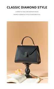 Detailed view of the elegant black genuine leather handbag featuring a stylish metal lock.
