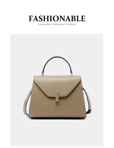 Close-up detail of the classic leather handbag featuring neat stitching and lock.