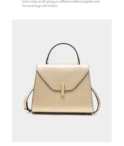 Elegant golden leather handbag with structured trapezoid design and metal clasp for women.