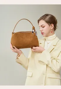 Stylish brown suede women's shoulder handbag with metallic ring and zipper for autumn.