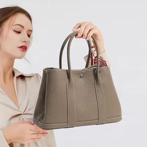 Grey genuine leather tote bag for women, large capacity commuting handbag with top handles.