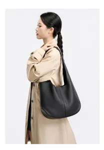 Detailed view of the black leather hobo shoulder bag worn on model, elegant daily style.
