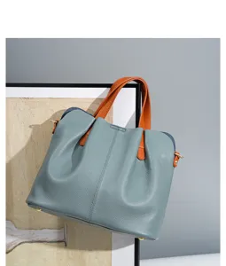 Detail view of the genuine leather color-blocked tote bag, showing fine texture and handles.