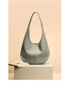 Grey leather hobo shoulder bag detailed view, showing soft texture and spacious capacity.