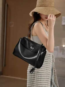 Black leather shoulder bag for women, large capacity commute hobo bag with stylish turn lock.