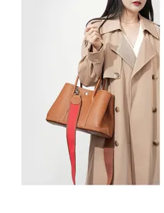 Detailed view of the premium leather garden tote bag with a striking red strap, elegant.
