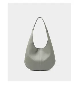 Grey cowhide shoulder bag detail view showing premium leather texture and elegant shape.