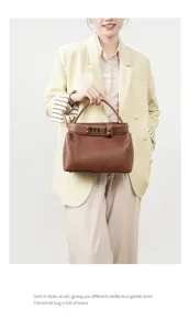 Elegant brown leather top-handle bag for women, stylish commuting handbag with chic metal details.
