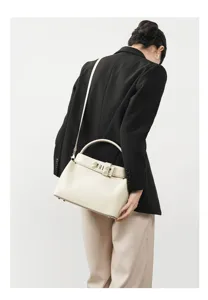 Elegant genuine leather shoulder bag with top handle and metal clasp for women daily use.