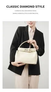Elegant beige leather handbag featuring a chic metal clasp and structured design for women.