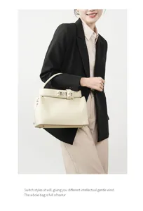Elegant genuine leather women shoulder handbag, chic commuter tote bag with unique buckle style.