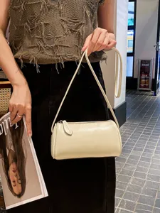 Minimalist beige cylinder shoulder bag for women, stylish soft leather crossbody handbag.