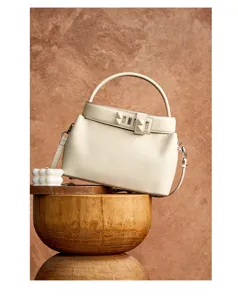 Elegant beige leather top-handle shoulder bag, premium design crossbody handbag detail.