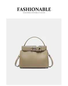 Elegant genuine leather top-handle crossbody bag for women, versatile commuting shoulder bag.