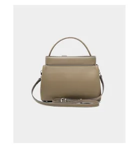 Taupe leather top handle bag, detailed view of premium pebbled texture, elegant design.