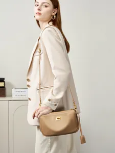 Elegant genuine leather shoulder bag for women, chic commuting crossbody bag with metal lock.