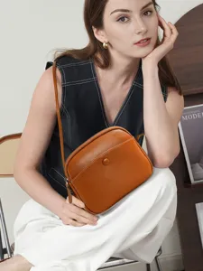 Stylish brown genuine leather crossbody bag for women, versatile casual shoulder bag commuter.