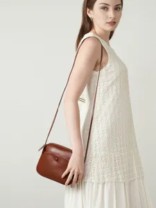 Elegant brown leather crossbody phone bag for women, premium minimalist design for daily commuting.