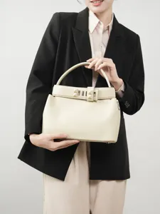 Elegant beige leather top handle bag for women, premium commuter shoulder handbag with chic design.