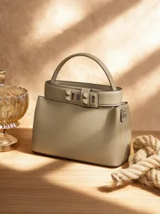 Elegant grey leather top-handle shoulder bag featuring distinctive pyramid stud buckle.