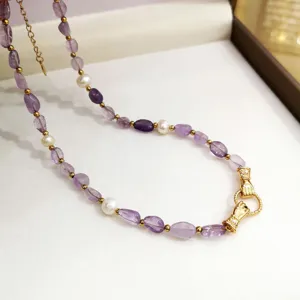Dettaglio squisito di collana di perle di ametista fatta a mano con chiusura unica.