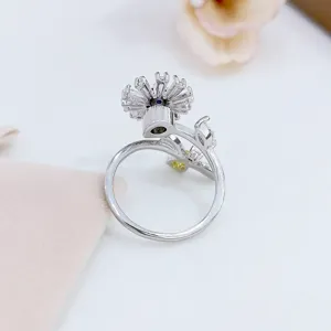 Primo piano anello fiore rotante, dettagli in zircone scintillante, elegante fascia in argento.