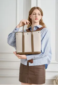 Vertical canvas leather tote bag detail showing premium texture, stitching and large capacity storage.