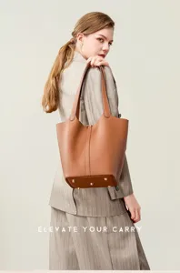 Genuine leather bucket bag detail showing premium cowhide texture, metal feet and strap.
