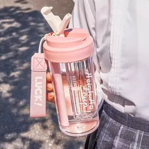 Pink large capacity plastic water bottle with straw and strap, stylish student cup for summer.