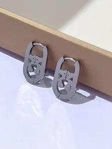 Primo piano dettagliato di orecchini in acciaio inossidabile con cuore d'orso dal design minimalista.