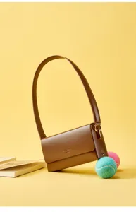 Details of the minimalist brown leather shoulder bag, stylish axillary design for women.